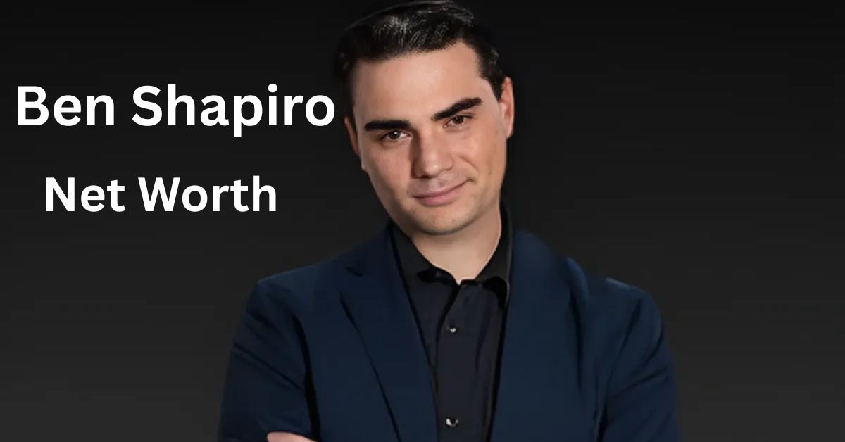 A person with their arms crossed in front of a black background