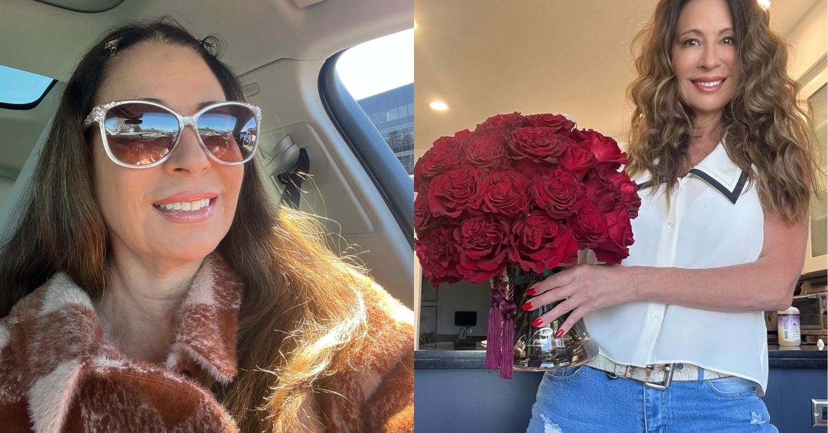 a person in jeans and a white shirt holding a bouquet of red roses