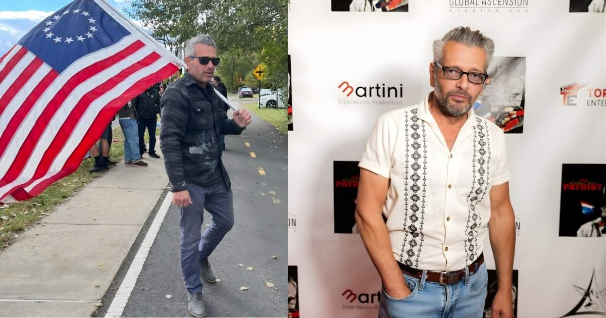 a person holding an american flag on the side of the road